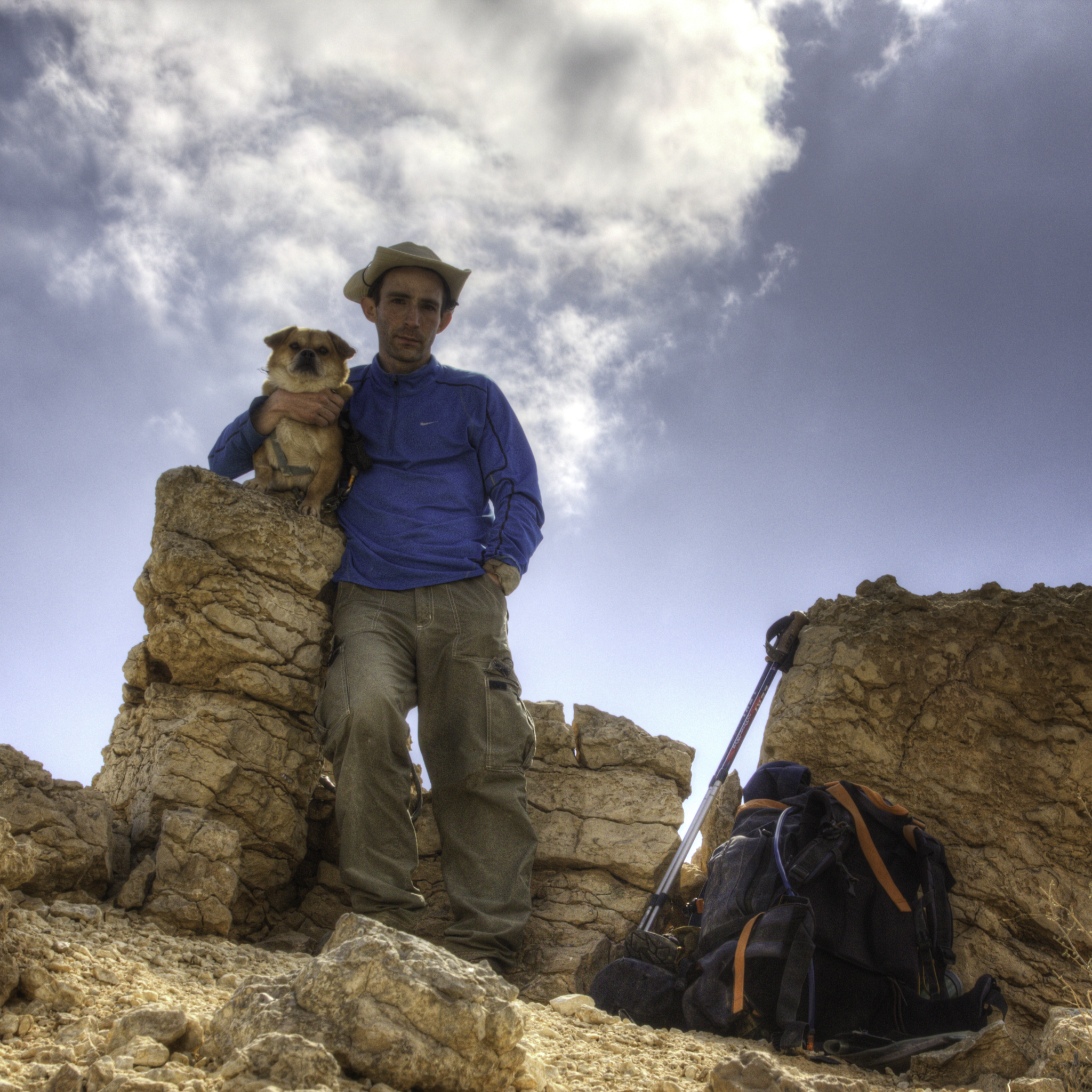 Assaf and his trusty companion Booli posing together atop a rocky crest