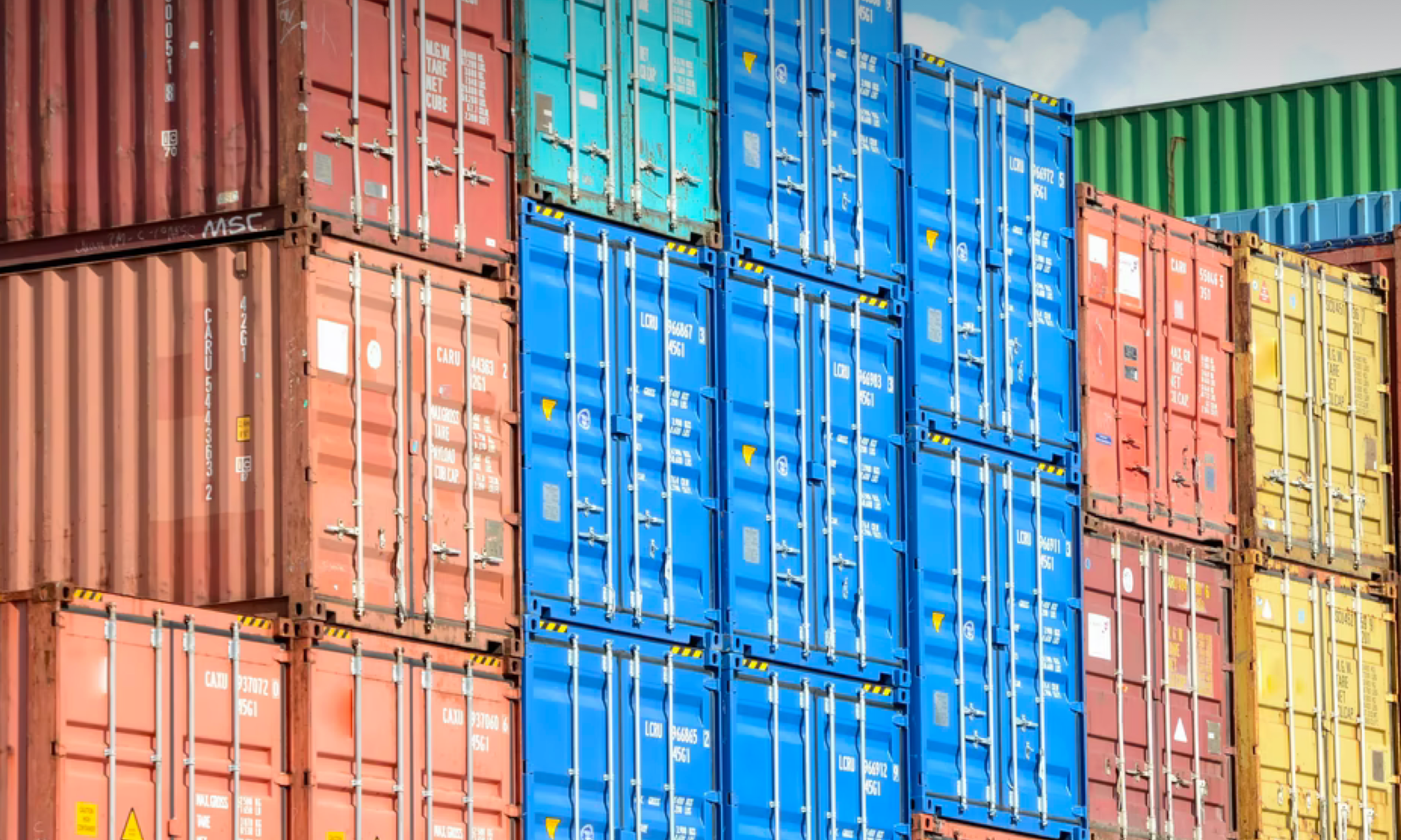 Shipping containers stacked at a port.